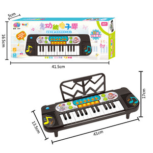 Children's toy keyboard with packaging displaying dimensions