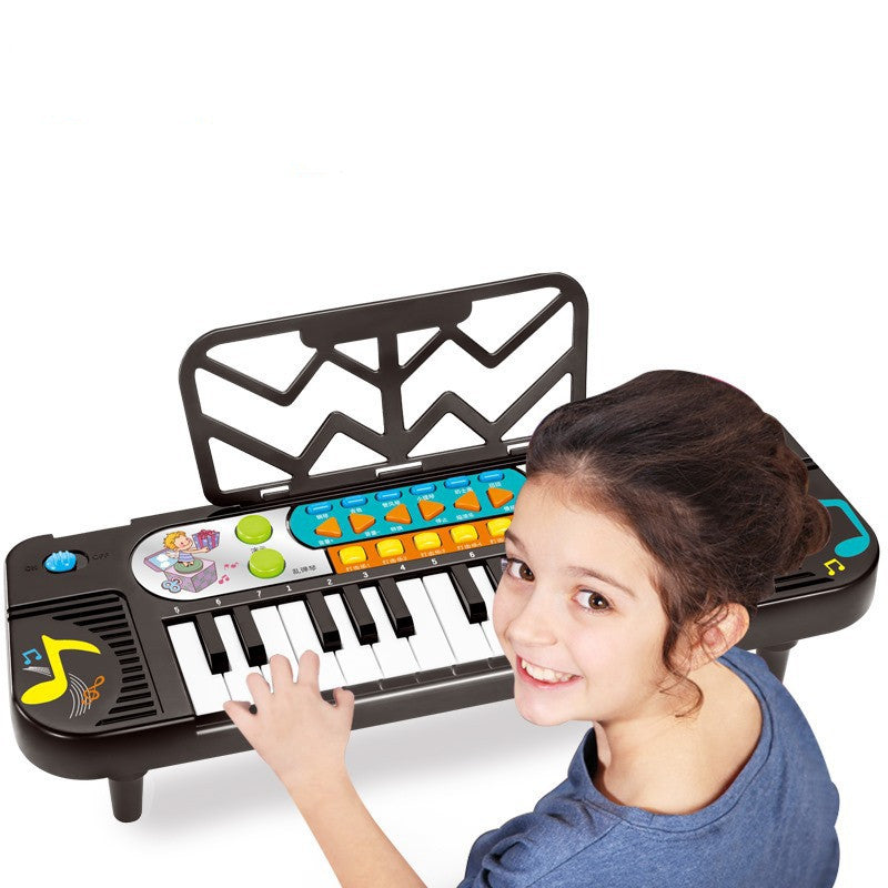 Child playing with a toy keyboard on a white background