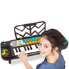 Child playing with a toy keyboard on a white background