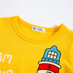 Yellow shirt with a cartoon lighthouse design and 'BE TOP' label on a white background